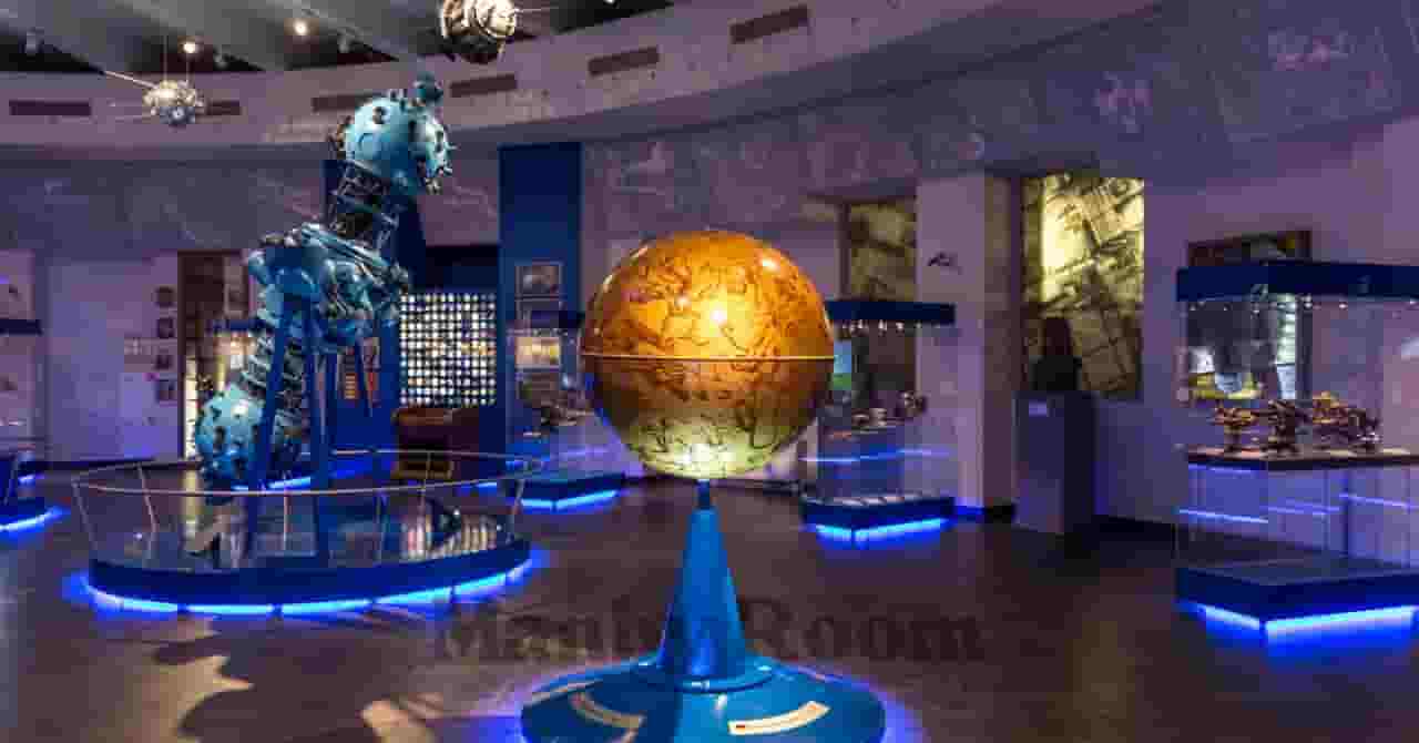 科学館の展示室にある大型の地球儀とプラネタリウム装置。知的好奇心を刺激する“パパと子の学びのお出かけ”を象徴するイメージ。 