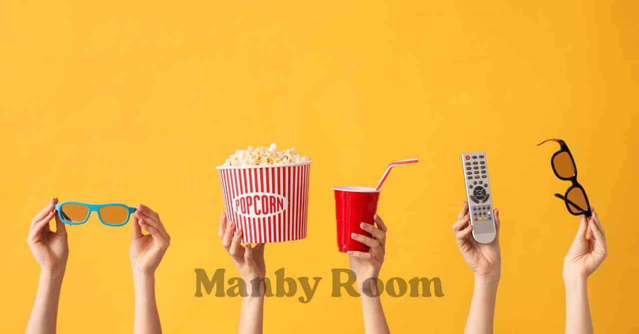 ポップコーンや飲み物、リモコンを手に持ったおうちシアターの準備風景